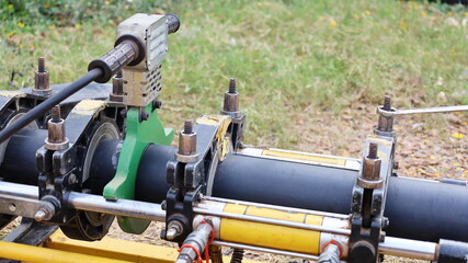 Heating Plate and HDPE Pipe. It is a heating process by heating plates at the ends of two polyethylene pipes and connecting plastic pipes on the machine with a copy area. Selective focus