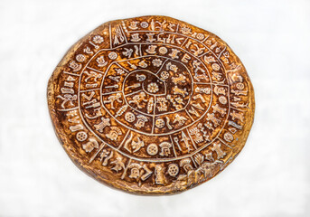 Clay copy of the Phaistos disc isolated on white background