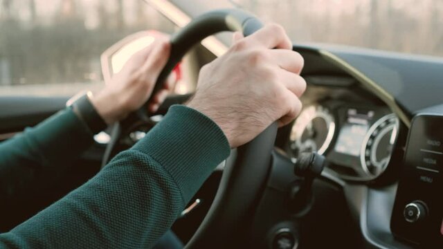 Man driving a modern Skoda auto. Front view to man drives a car. Male hands on the steering wheel, March 2021, Prague, Czech Republic. 