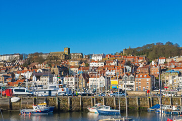 Harbor seafront town with medieval church on hill