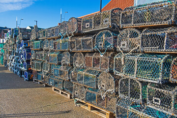 Lobster pots stacked up on a harbor quayside