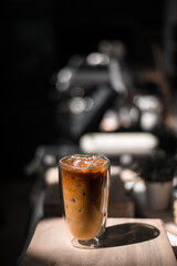 Close-up glass of iced coffee with milk on the table