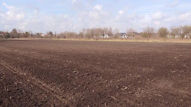 Arable land. Preparing field for planting. Plowed soil in spring time . Agricultural work.