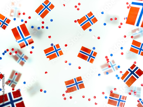 Norwegian independence day, Constitution day, may 17. holiday of freedom, victory and memory. concept of patriotism and faith. paper confetti and mini flags on white foggy background