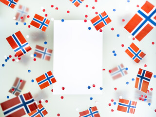 Norwegian independence day, Constitution day, may 17. holiday of freedom, victory and memory. concept of patriotism and faith. paper confetti and mini flags on white foggy background