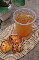 Iced Bael Fruit Juice-Herbal Drink in glass Decorated with dried Bael Fruit giving a fresh feeling.