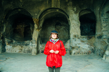 girl near Uplistsikhe Cave City, Cave Town. Old Ancient Cave in Georgia.