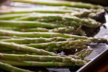Fresh green asparagus rinsing in water