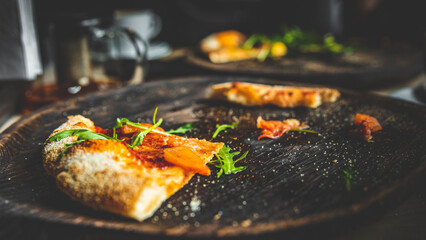 last slice of pizza on black wooden board in cafe