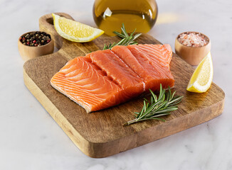 Fresh raw Atlantic salmon on the wooden board. Great source of omega-3 fatty acids, protein, potassium, and selenium.