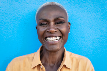 Happy African woman portrait - Afro senior female having fun smiling while posing in front of camera