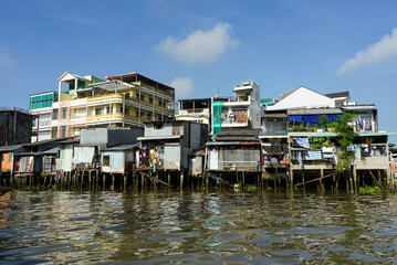 Fototapeta na wymiar Houses standing on pillars in the Mekong river, Vietnam