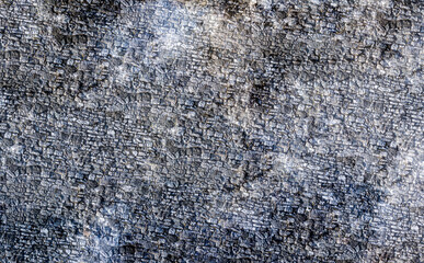 stone background of old naked and weathered cobble stones old square
