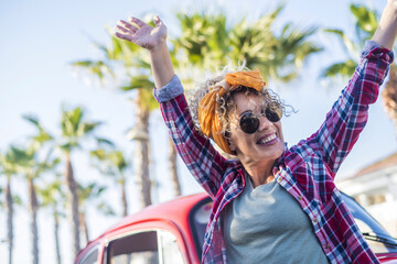 Excited pretty young trendy woman outdoor enjoy summer lifestyle - travel female people single life...