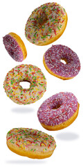 Fototapeta na wymiar flying donuts isolated on white background. selective focus. set of multicolored crumpets. sweet doughnuts, traditional confectionery products. icing sugar with sprinkles.
