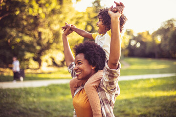 African American mother and daughter playing in the park. - 423360015