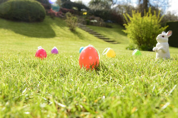 Fototapeta na wymiar easter photography with eggs and rabbit in a garden