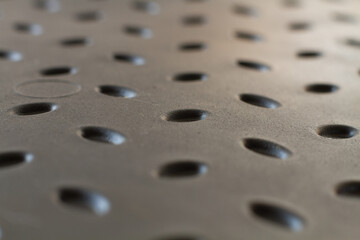 A background of bulging pimples. Plastic shoe tray. Background with gray raised details. Bulging oval elements