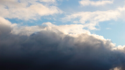 The sky is blue with clouds and a dark thundercloud is approaching.