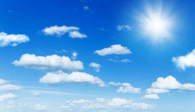 Sunny background, blue sky with white clouds and sun as summer or spring natural background.