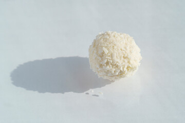 Delicate white candy with almond in coconut sprinkling