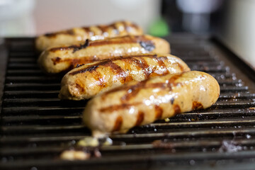 fried pork sausages and tasty beer snack, lies on the grill
