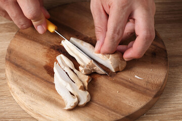 chef cut mushrooms on wooden tray