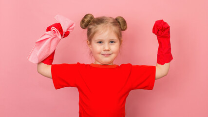 Pretty child in red t-shirt and red gum gloves showing strength gesture. Little happy smiling girl on pink background ready for cleaning.
