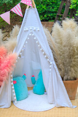 Cute and small white tent for kids play for toys.