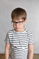 Fototapeta premium Upset and angry boy concept for anger, frustration and mischief with copy space