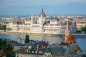 Fototapeta na wymiar Budapest, Hungary - June 20, 2019: View to Hungarian Parliament Building from Castle District located on Buda side of the city