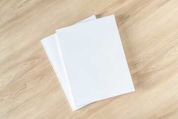 Book cover mockup with blank white front paper page a4 paperback mock up for catalog, magazine, menu, booklet, notebook, portfolio design template on wood table background