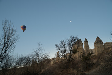 Fototapeta na wymiar Hot air balloon flying over magnificent Cappadocia, Goreme, love valley at sunrise.