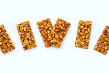 Honey bars with peanuts on white background