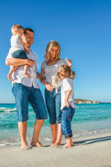Fototapeta na wymiar happy family by the sea in the open air
