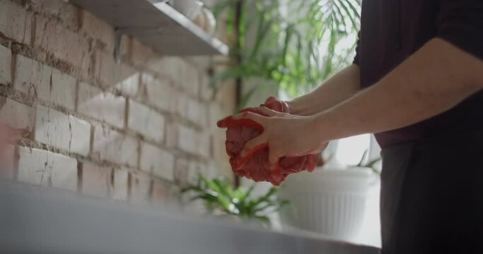 Potter kneads clay with dye in slow motion, pottery at workshop, potter prepares clay for making nerikomi style ceramics, ceramist at work, 4k 60p Prores HQ 10 bit