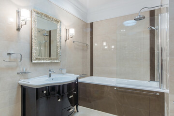 Classic style new bathroom with sink, designed mirror and tub. Interior design