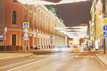 Moscow, Russia, Mar 4, 2021: Night view of Ilyinka street. Lanterns,  lights, traffic. Long...
