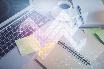 Double exposure of arrows drawing and desktop with coffee and items on table background. Concept of...