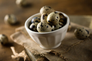 Healthy organic quail eggs in a white bowl