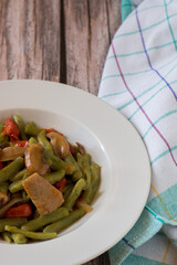 Cavatelli with spinach. Typical Italian homemade pasta with cherry tomatoes and mixed mushrooms in white plate.