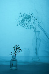 Still life with glass objects on a blue background. For interior printing. For the poster