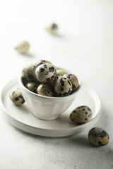 Healthy organic quail eggs in a white bowl