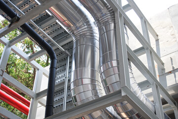 Fototapeta premium Chilled water system pipes with insulation and cladding it with a roll of aluminum sheet.