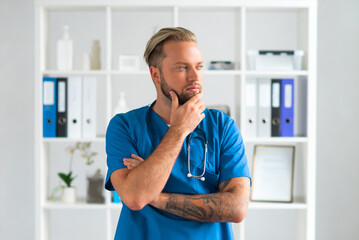 Professional medical doctor in hospital office, Portrait of young and confident physician.