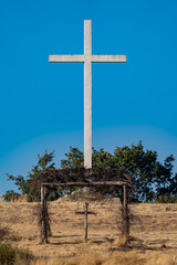 Huge stone cross over small wooden one