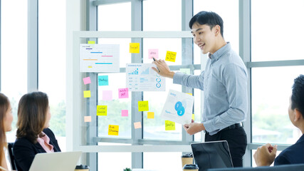 Businessman presenting business plan information at office meeting, Asian man explaning business...