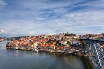Fototapeta na wymiar Oporto, Portugal, Europe. Postcard from the picturesque city of Porto, amazing travel destination in Portugal. View to the historic center, Douro River with its beautiful bridge and old monuments.
