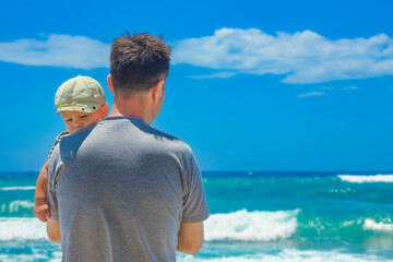Fototapeta premium happy parent with a child by the sea in the open air