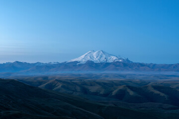 Fototapeta premium Late blue hour view of Mount Elbrus from Bermamyt plateau. Karachay-Cherkessia, Caucasus, Russia.